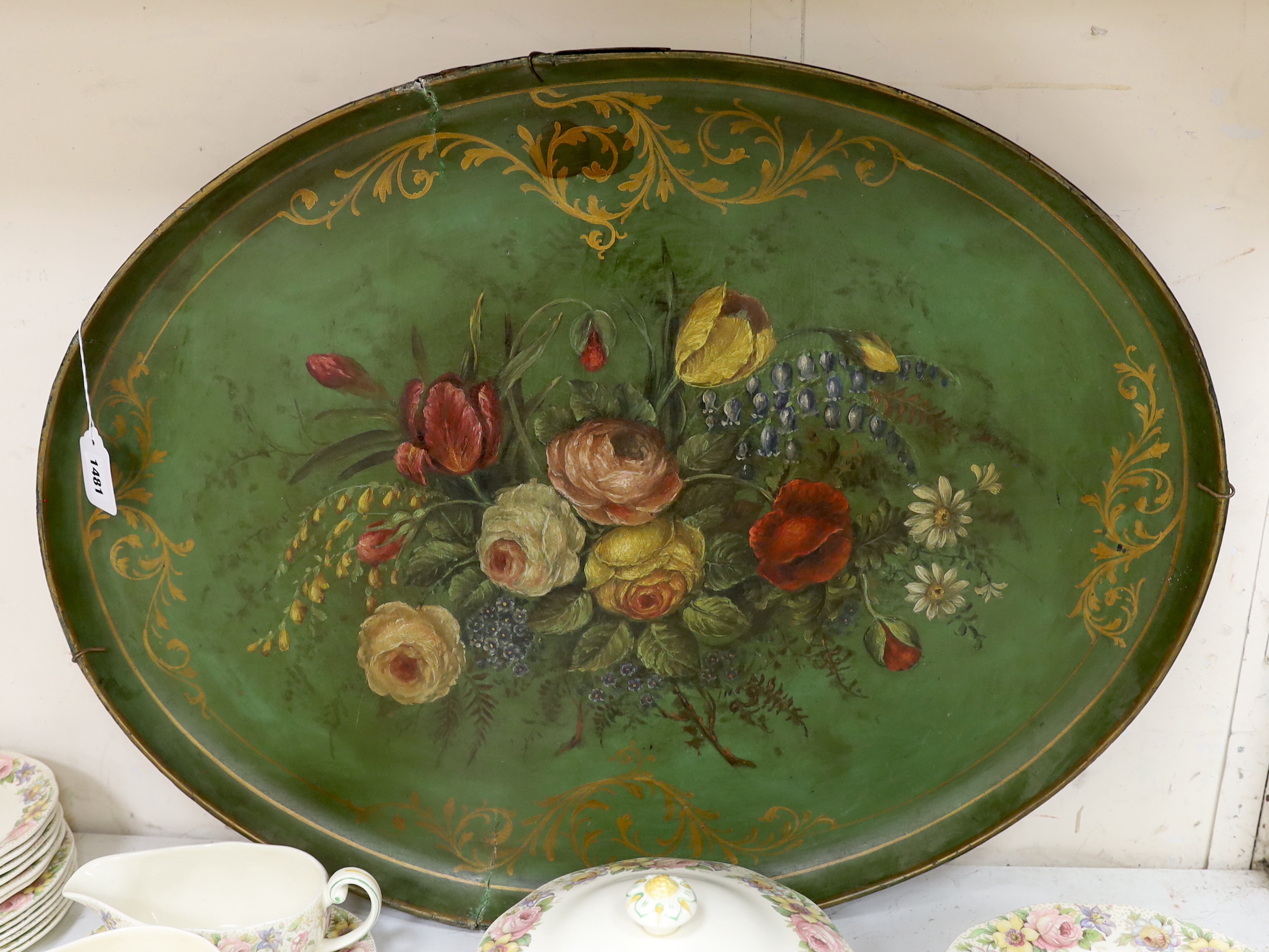 A large 19th century papier maché tray, painted with floral still life, 76cm wide